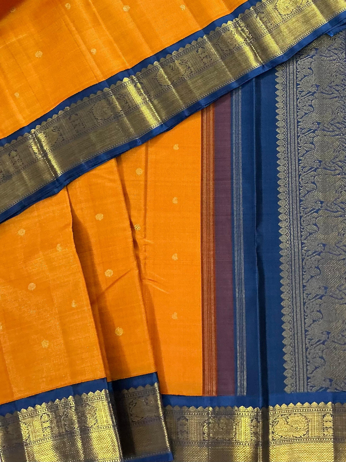 MYTHILI:   Korvai Kanjivaram Silk (Carrot Orange + Burnt blue)