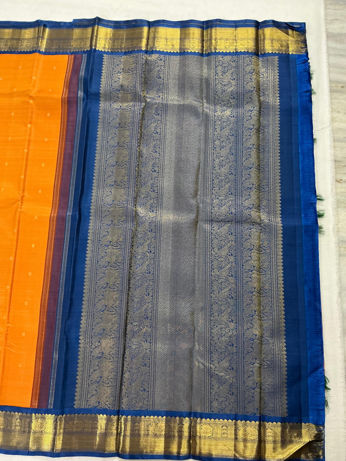 MYTHILI:   Korvai Kanjivaram Silk (Carrot Orange + Burnt blue)