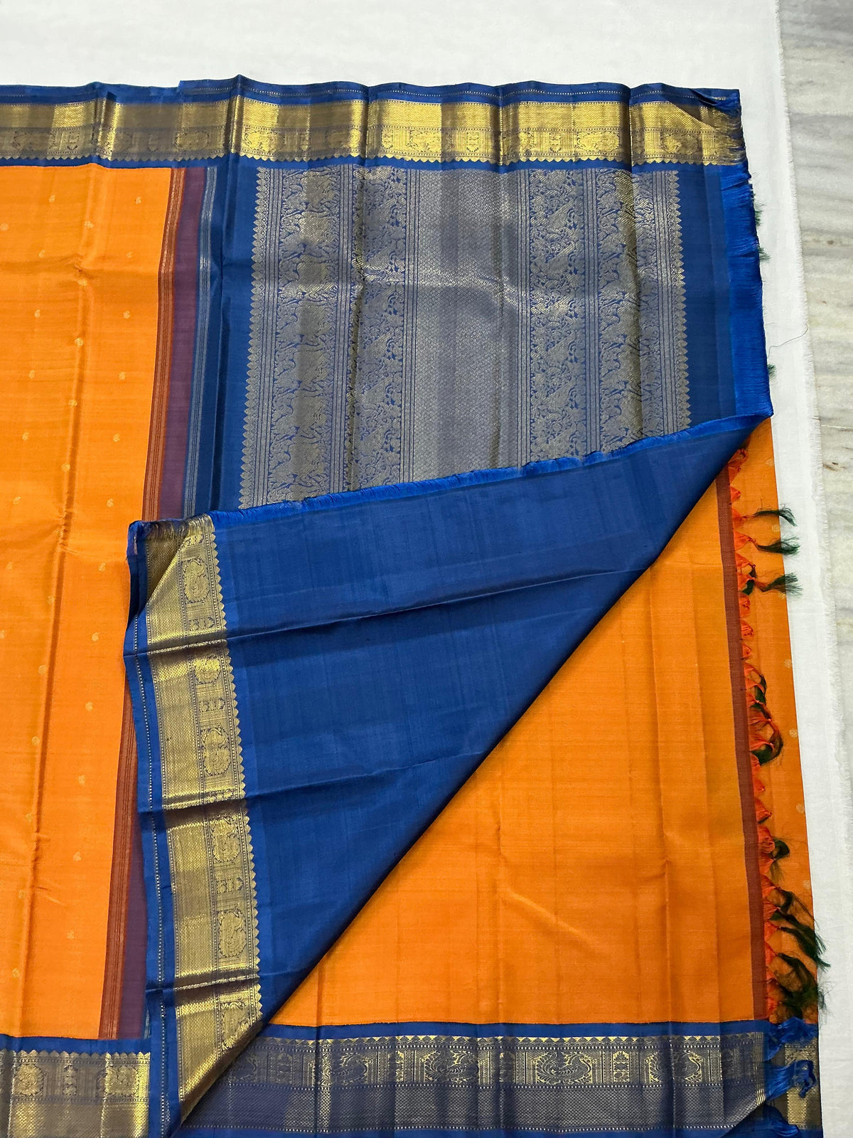 MYTHILI:   Korvai Kanjivaram Silk (Carrot Orange + Burnt blue)